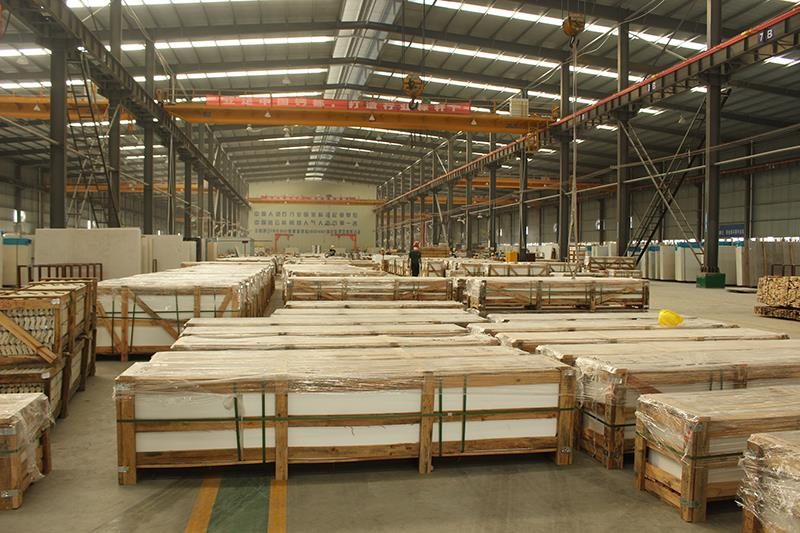 Engineered stone slabs in wooden bundles on the plant floor